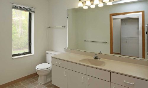 Tile Floor In Bathroom and Large Mirror