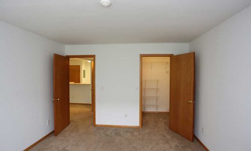 Bedroom with Doors to Living Room and Closet